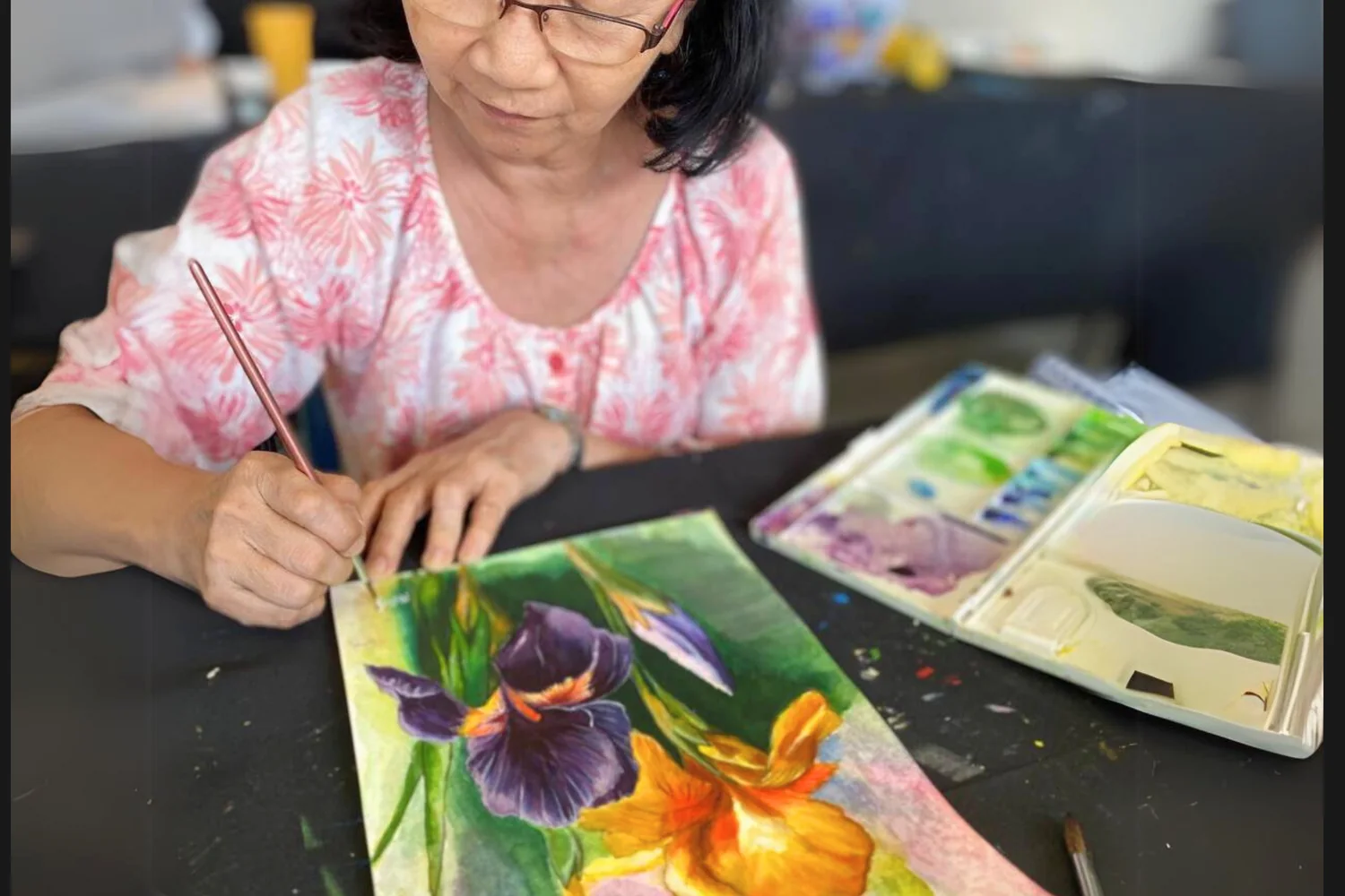 Adult student painting a flower artwork during Rycca class