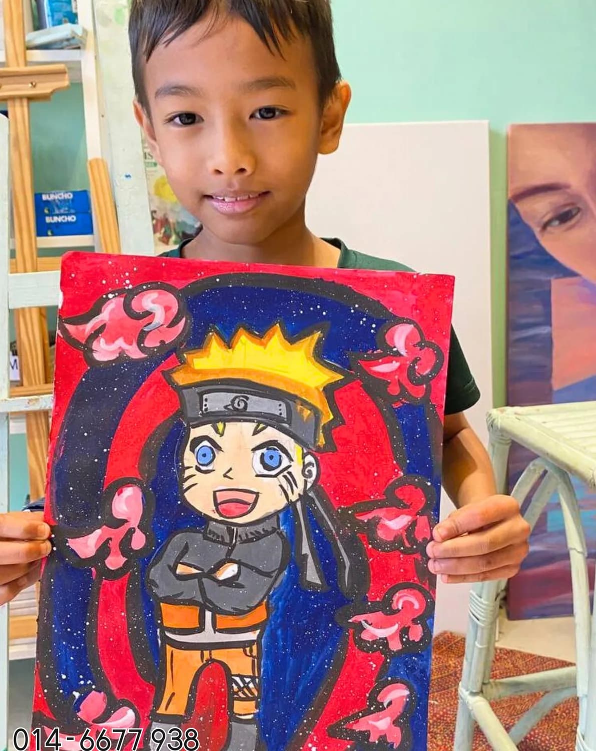 Boy holding ninja anime painting from Rycca drawing and painting class