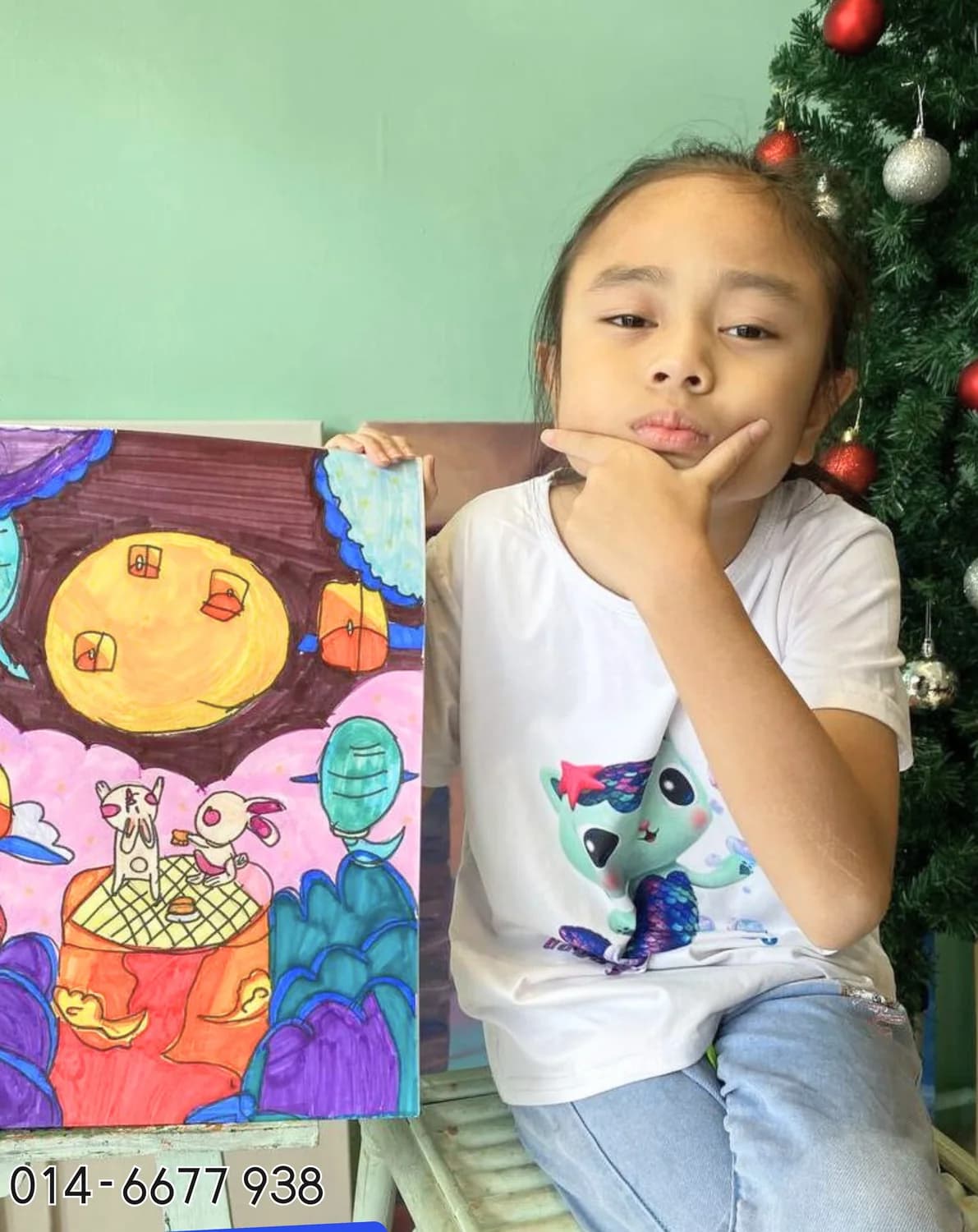Girl posing with portrait style artwork from Rycca art class